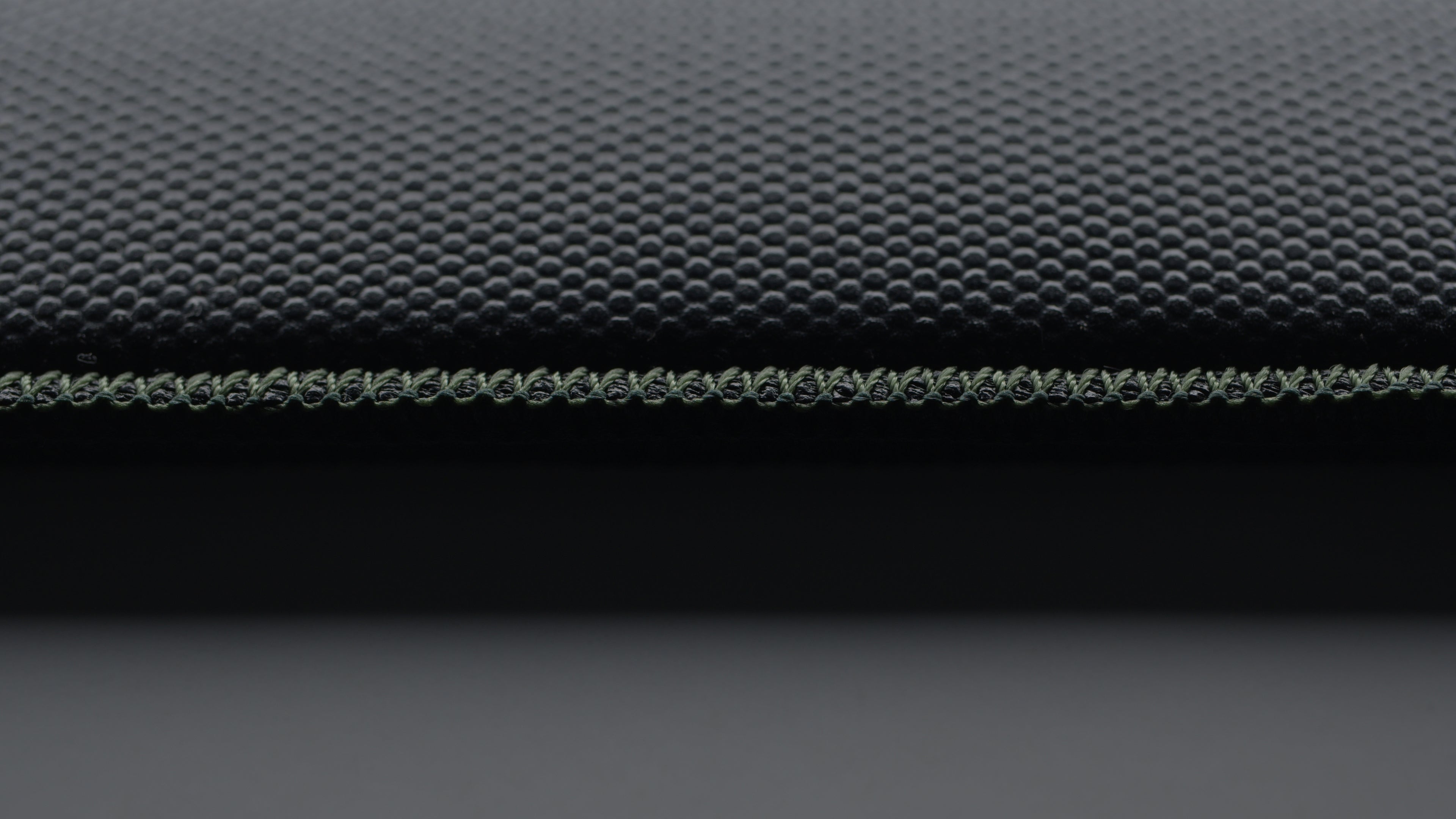 Show the quality and durability of the stitching from the bottom of the mousepads. 